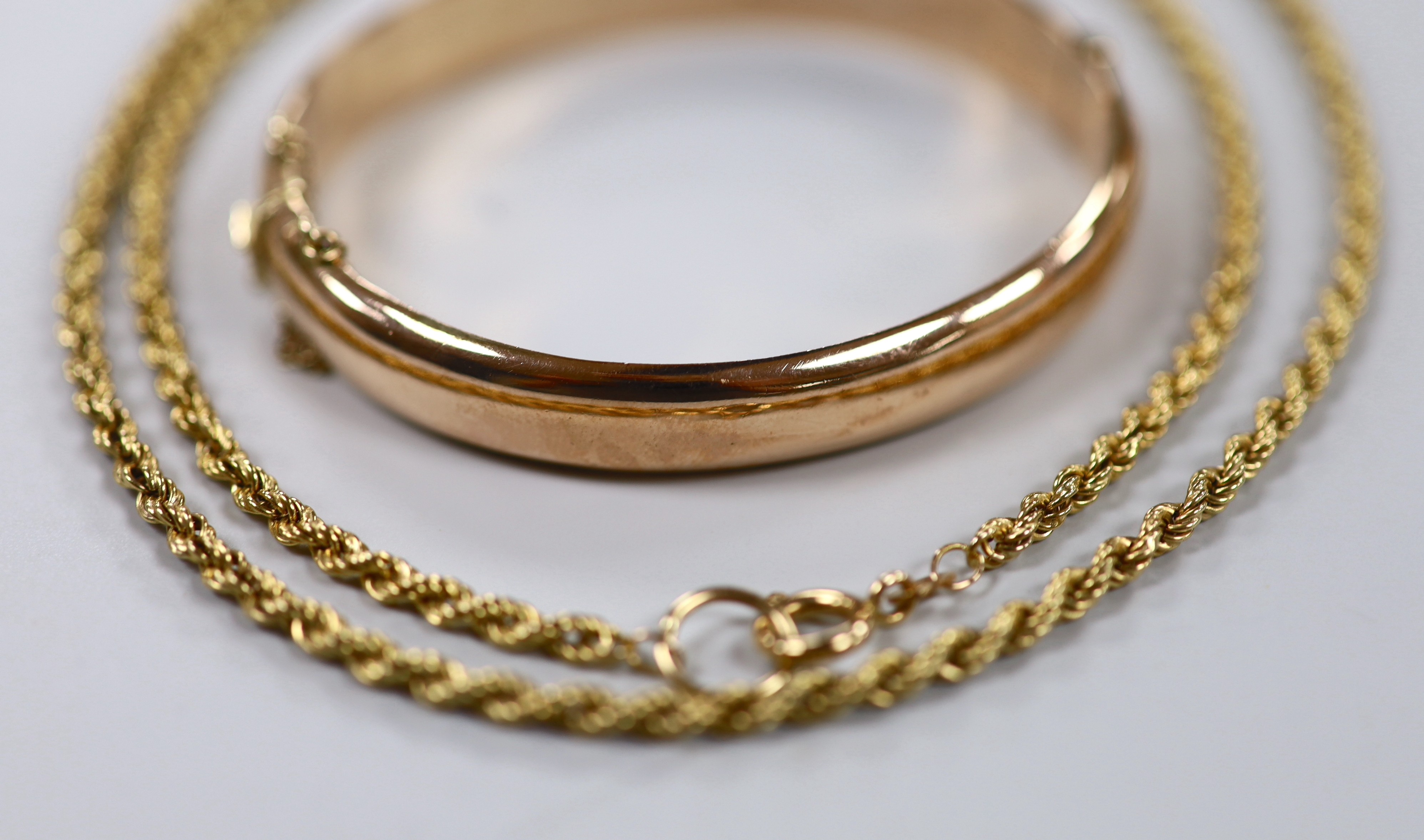 A modern 9ct gold ropetwist chain, 52cm and a 9ct gold hinged bangle, 19.7 grams.